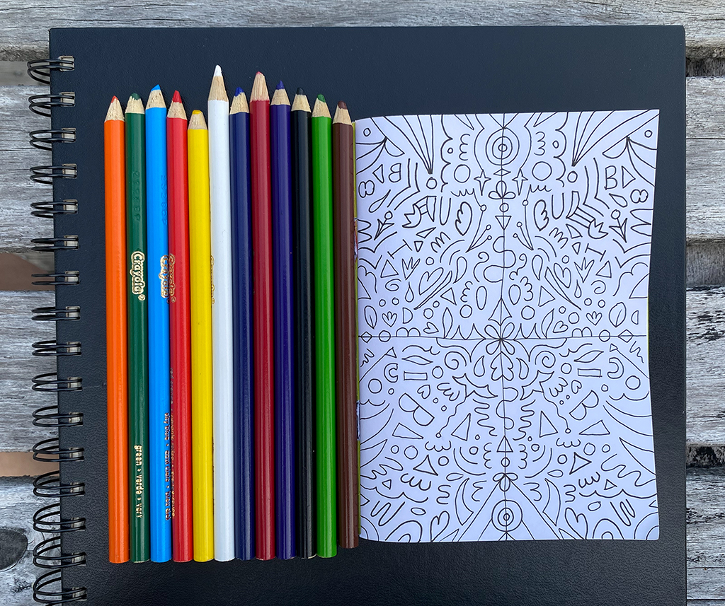 Some drawing pads with coloured pencils.